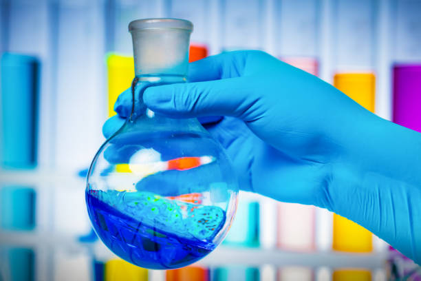 Scientist injecting liquid from syringe into fruits and vegetables.Genetically modified organism - apple and laboratory glassware.
