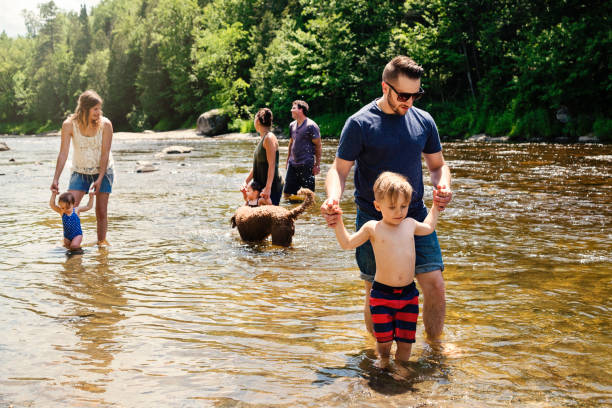 istock Millennials families bathing in a river in summer nature. 913048718