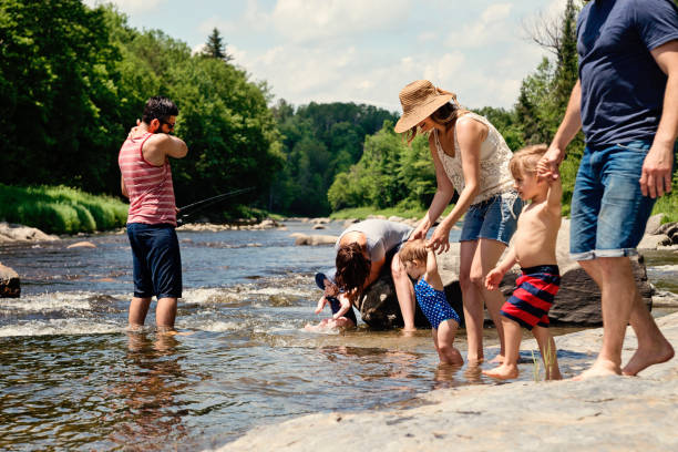 istock Millennials families bathing in a river in summer nature. 913048986