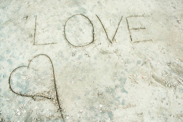 istock Love written in the sand. 913054864