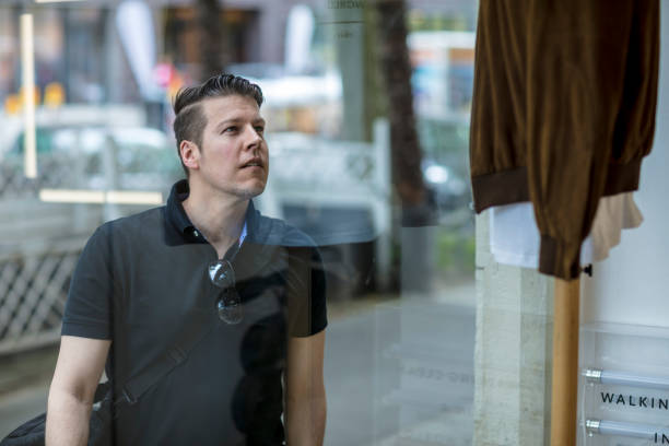 istock Handsome Young Man Seen Through Glass Window 913055432