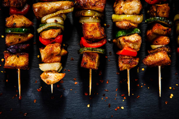 istock Kebabs - grilled meat and vegetables on wooden background 913058836