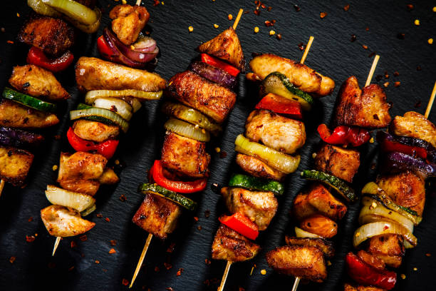 istock Kebabs - grilled meat and vegetables on wooden background 913058924