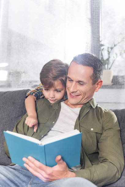 istock father and son reading book together 913059030