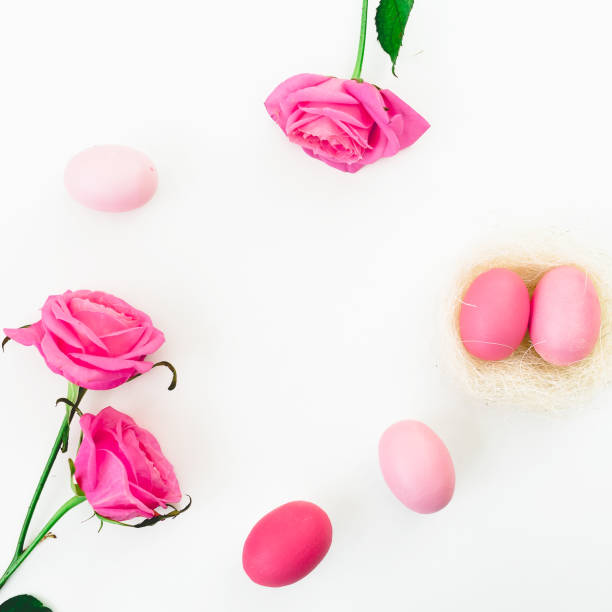 istock Easter egg and quail eggs in nest and pink roses on white background. Top view, Fat lay. Easter holiday concept. 913062316