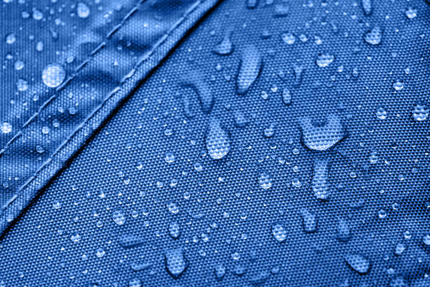 Dark blue rainproof tent sheet with morning rain drops stock photo