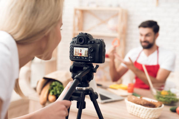istock Chef prepering food ingredients for culinary podcst program. Vegetables and kitchen utensils. 913065970