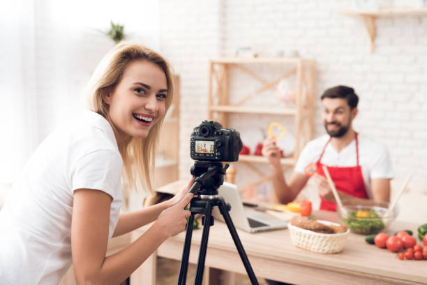istock Chef prepering food ingredients for culinary podcst program. Vegetables and kitchen utensils. 913065978