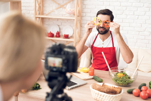 istock Chef prepering food ingredients for culinary podcst program. Vegetables and kitchen utensils. 913065998