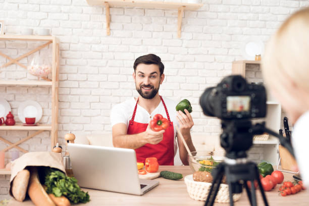 istock Chef prepering food ingredients for culinary podcst program. Vegetables and kitchen utensils. 913066010
