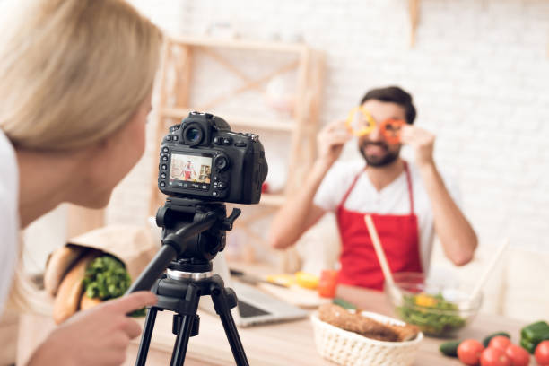 istock Chef prepering food ingredients for culinary podcst program. Vegetables and kitchen utensils. 913066014