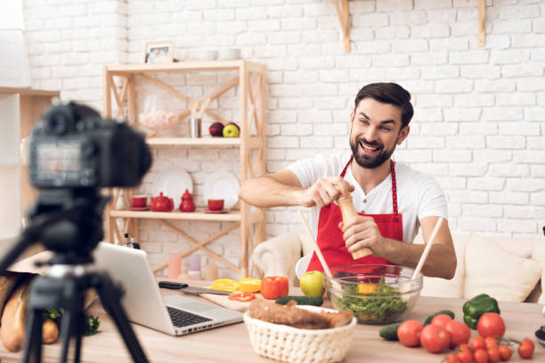 istock Chef presenting food ingredients for culinary podcst viewers. Vegetables and kitchen utensils. 913066016