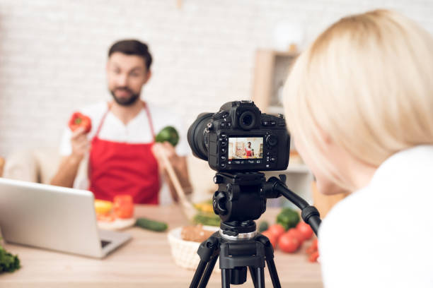 istock Chef presenting food ingredients for culinary podcst viewers. Vegetables and kitchen utensils. 913066036