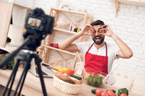 istock Chef presenting food ingredients for culinary podcst viewers. Vegetables and kitchen utensils. 913066076