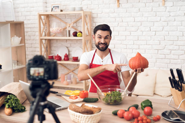 istock Chef presenting food ingredients pumpkin for culinary podcst camera. Vegetables and kitchen utensils. 913066100
