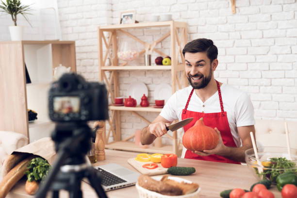 istock Chef presenting food ingredients pumpkin for culinary podcst camera. Vegetables and kitchen utensils. 913066108