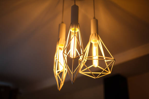 istock Industrial pendant lamps against rough wall loft interior edison bulbs 913072222