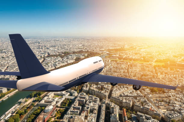 istock Airplane flying on a big city 913072650