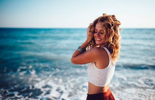 Girl in boho style relaxing at the beach in summer