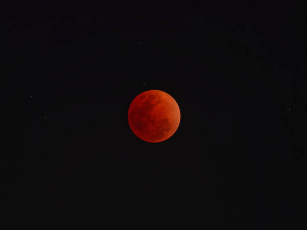 istock Super blue blood moon with total lunar eclipse over dark sky background 913075234