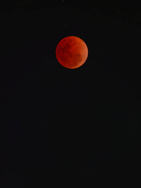 istock Super blue blood moon with total lunar eclipse over dark sky background 913075294