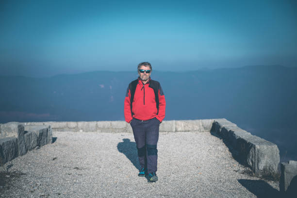 Senior man walking outdoors, Sveta Gora, Primorska, Slovenia, Europe. Nikon D850.