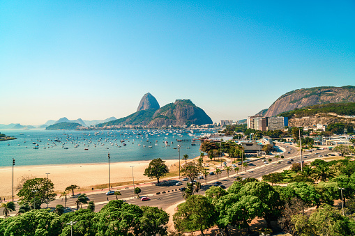 Brazilian flag in foreground and Christ looking at Favela (Shanty Town) in Rio De Janeiro, Brazil