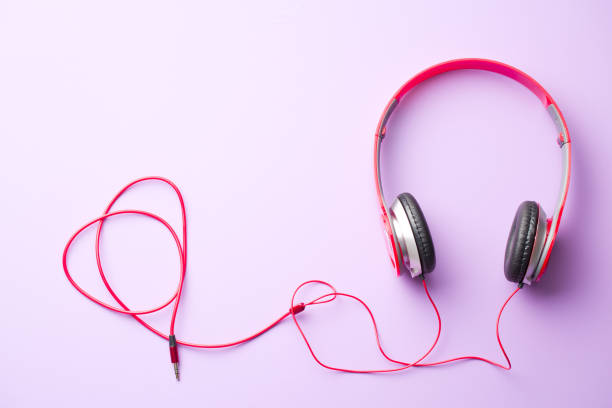 istock red headphones on violet background 913075804