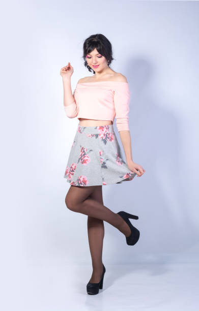 istock Young woman with a rose smiles on a white background 913076214