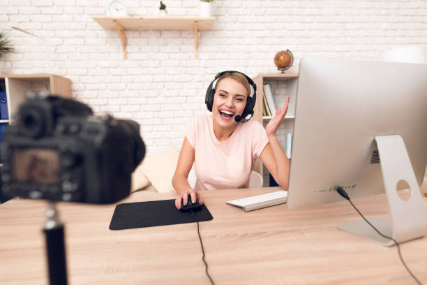 istock Woman podcaster posing at camera for radio podcast. 913076264