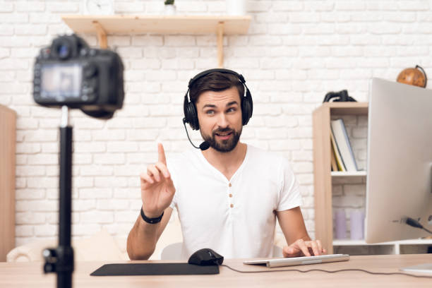 istock Man podcaster posing at camera for radio podcast. 913078342