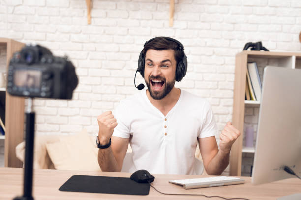 istock Man podcaster posing at camera for radio podcast. 913078356