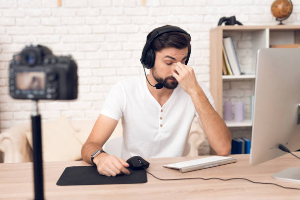 istock Camera shoots man podcaster posing for radio podcast. 913078396