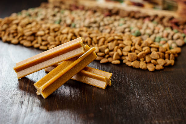 istock Dry pet food on black wooden table. 913082502