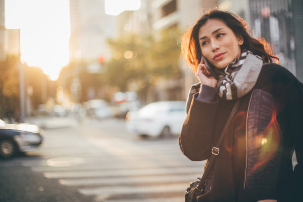 istock Japanese woman talks on mobile 913083782