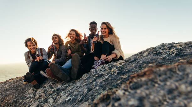 istock Diverse group of friends having beers on mountain top 913084172