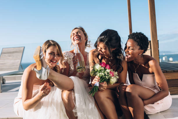istock Bride and bridesmaids on rooftop having fun before wedding 913085258