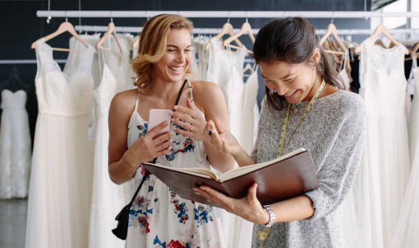 istock Female client in bridal boutique with tailor 913087198