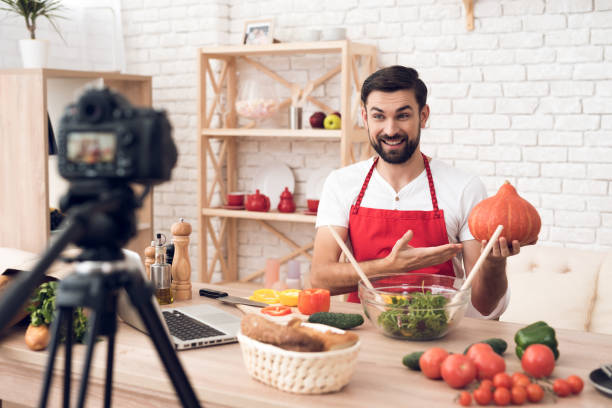 istock Chef presenting food ingredients pumpkin for culinary podcst camera. Vegetables and kitchen utensils. 913087870