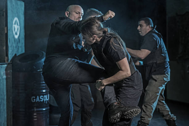 istock Female Krav Maga fighting instructor sparring during training session in grimy outdoor setting 913088296