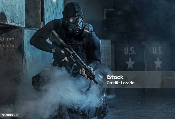 Gas Mask Wearing Lone Soldier In Smoky Indoor Urban Setting Stock Photo - Download Image Now