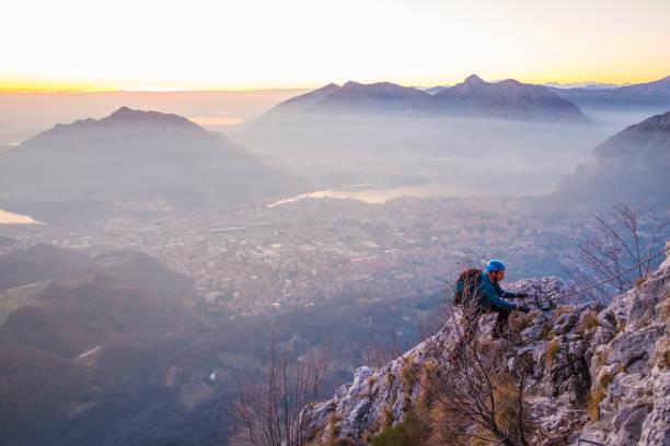 istock Alpinist climbing mountain, city in background 913091152