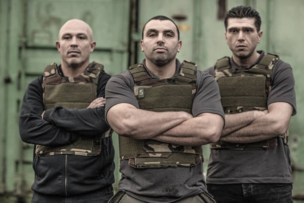 Krav Maga fighting group posing for team picture in grimy outdoor setting