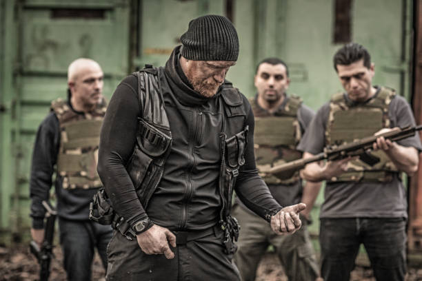 istock Krav Maga fighting instructor leading a training session in grimy outdoor setting 913094432