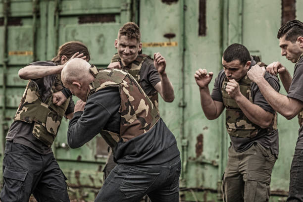 istock Krav Maga fighting group sparring during training session in grimy outdoor setting 913094440