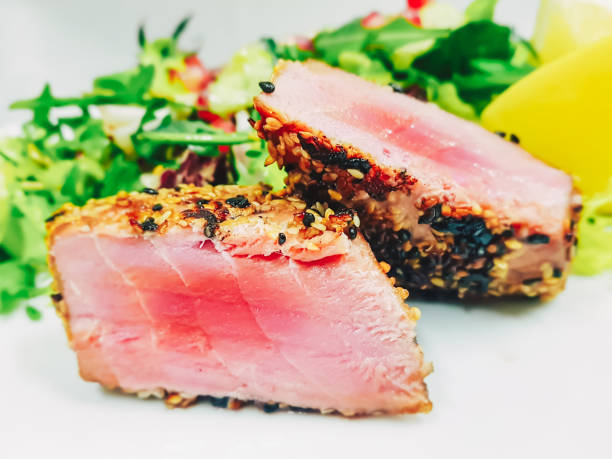 istock Tuna fish meat cut in two pieces and cooked with sesame seeds 913094486