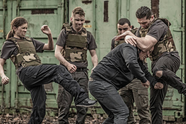 istock Krav Maga fighting group sparring during training session in grimy outdoor setting 913094602