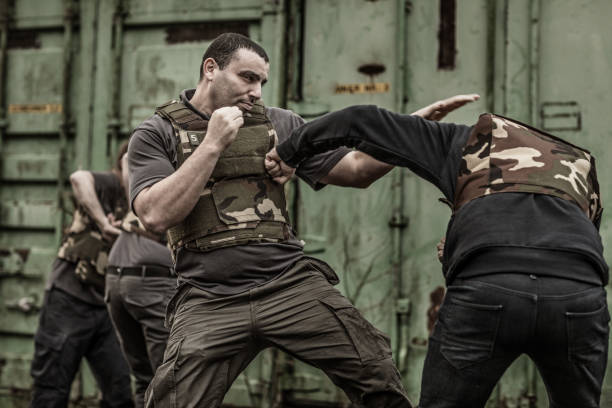 istock Krav Maga fighting group sparring during training session in grimy outdoor setting 913094616
