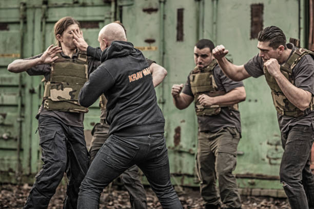 istock Krav Maga fighting group sparring during training session in grimy outdoor setting 913094684