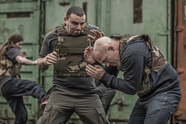 istock Krav Maga fighting group sparring during training session in grimy outdoor setting 913094808